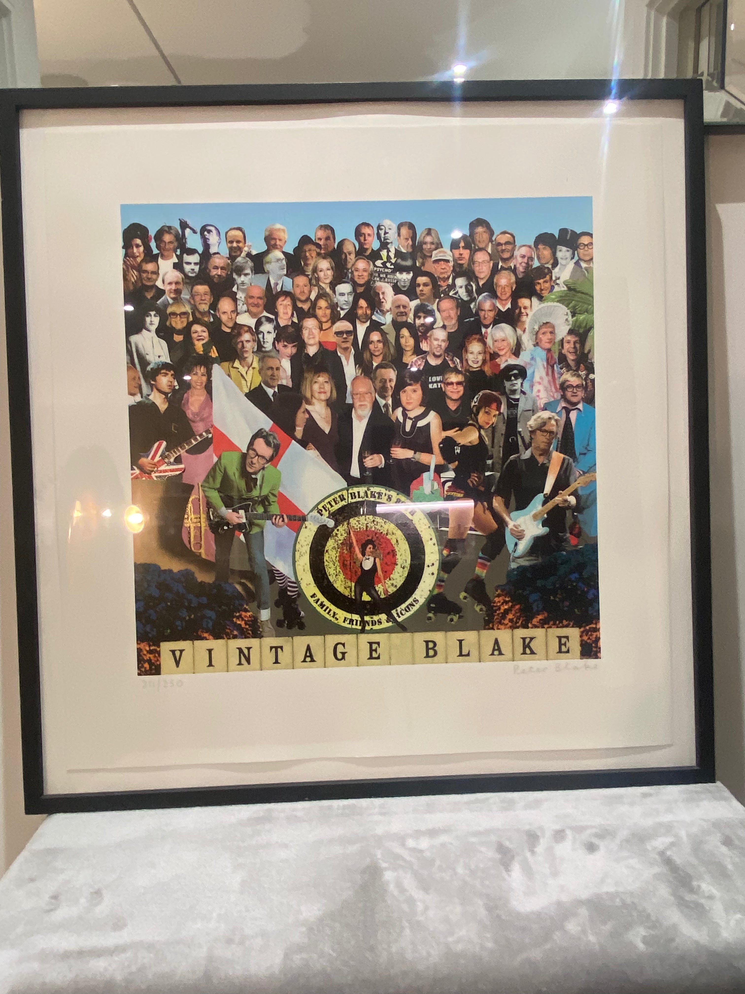 Framed artwork with a collage of people and 'Vintage Blake' branding.